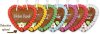 Examples of gingerbread hearts with different colors, icing decoration, and slogan stickers