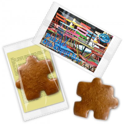 Gingerbread puzzle piece, with promotional card in flowpack