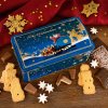 “Santa Claus” gingerbread chest surrounded by speculoos, Lebkuchen, cookies, and Christmas decorations