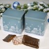 Christmas tins surrounded by rectangular Nuremberg Elisen gingerbread cookies and Christmas decorations